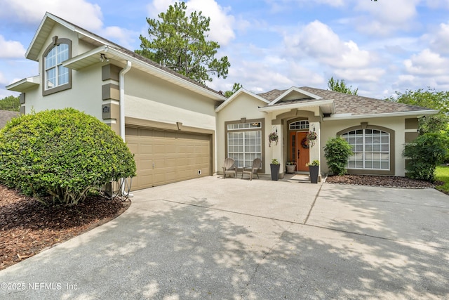 4340 Comanche Trail Blvd, Saint Johns, FL 32259 - view of front facade with stucco siding, driveway, and an attached garage