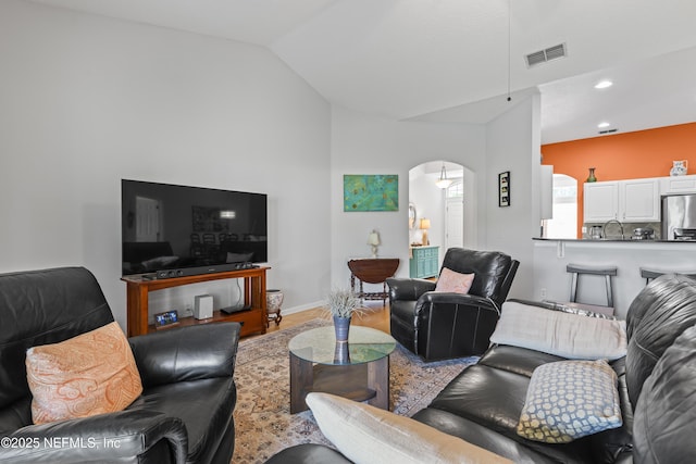 4340 Comanche Trail Blvd, Saint Johns, FL 32259 - living room with arched walkways, vaulted ceiling, wood finished floors, and recessed lighting