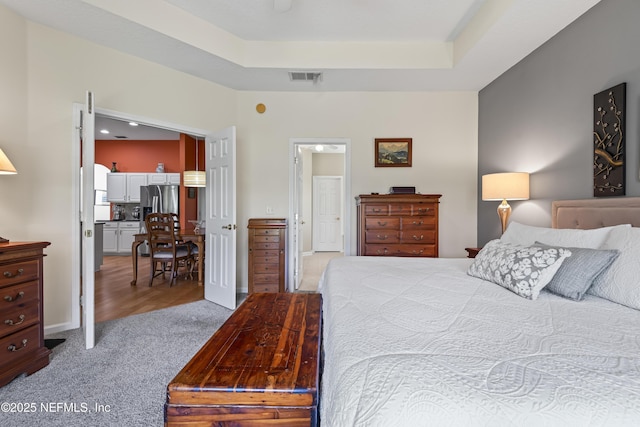4340 Comanche Trail Blvd, Saint Johns, FL 32259 - bedroom with stainless steel fridge, light colored carpet, and a raised ceiling