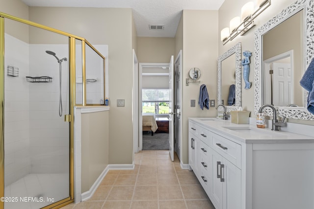 4340 Comanche Trail Blvd, Saint Johns, FL 32259 - full bath with ensuite bath, a stall shower, double vanity, tile patterned flooring, and a textured ceiling