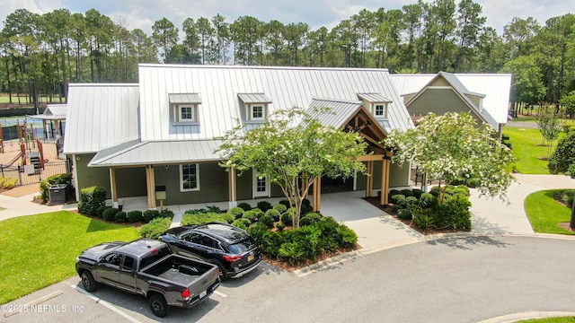 4340 Comanche Trail Blvd, Saint Johns, FL 32259 - townhome / multi-family property with a standing seam roof, view of scattered trees, a front lawn, and uncovered parking