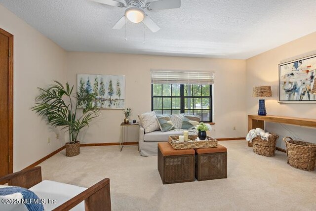 2768 N Periwinkle Ave, Middleburg, FL 32068 - carpeted living room with a textured ceiling, a ceiling fan, and baseboards