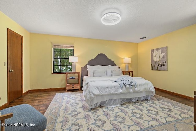 2768 N Periwinkle Ave, Middleburg, FL 32068 - bedroom with wood finished floors, baseboards, and a textured ceiling