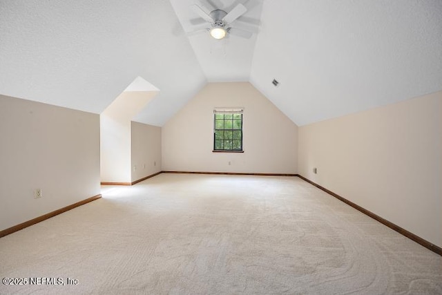 2768 N Periwinkle Ave, Middleburg, FL 32068 - bonus room with light colored carpet, lofted ceiling, a ceiling fan, and baseboards