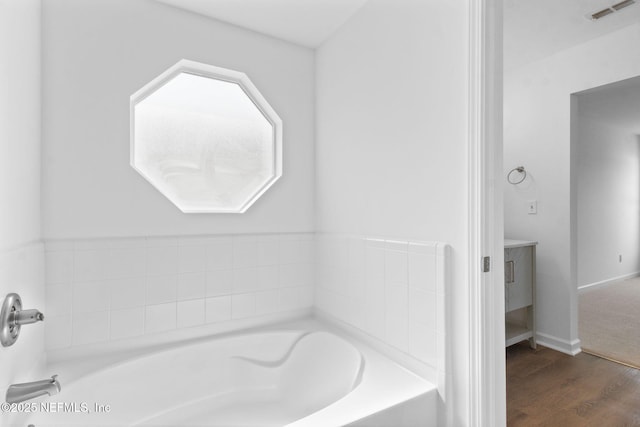 96002 Coral Reef Rd, Yulee, FL 32097 - full bath featuring a garden tub and wood finished floors
