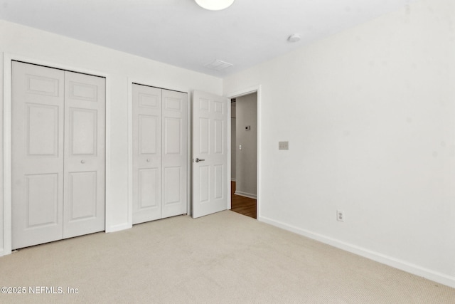 96002 Coral Reef Rd, Yulee, FL 32097 - unfurnished bedroom featuring multiple closets, carpet flooring, and baseboards