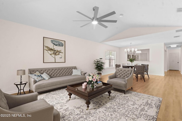 96002 Coral Reef Rd, Yulee, FL 32097 - living room featuring a chandelier, lofted ceiling, light wood-style floors, ceiling fan, and baseboards