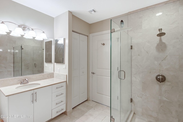 1431 Riverplace Blvd Unit 2202, Jacksonville, FL 32207 - bathroom featuring a marble finish shower, vanity, and a closet