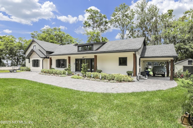 10351 County Road 13 N, Saint Augustine, FL 32092 - modern farmhouse style home featuring a front yard, board and batten siding, a shingled roof, and covered porch