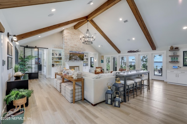 10351 County Road 13 N, Saint Augustine, FL 32092 - living area featuring a barn door, beam ceiling, light wood-style floors, recessed lighting, and a chandelier