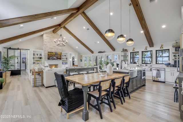 10351 County Road 13 N, Saint Augustine, FL 32092 - dining space with beam ceiling, a large fireplace, light wood finished floors, recessed lighting, and a chandelier