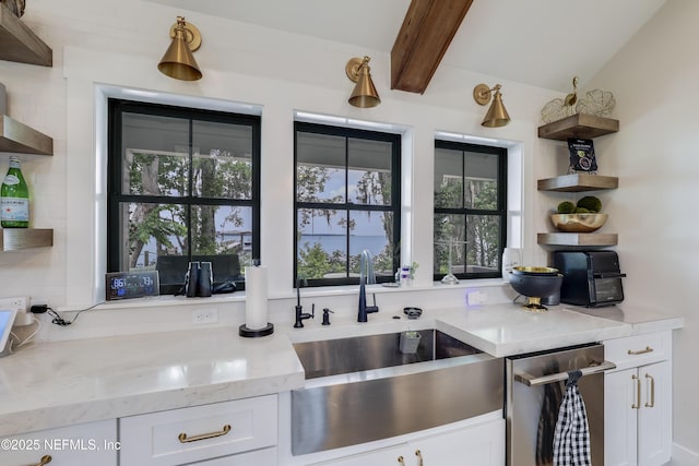 10351 County Road 13 N, Saint Augustine, FL 32092 - kitchen featuring open shelves, a sink, white cabinets, beamed ceiling, and light stone counters