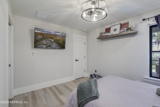 10351 County Road 13 N, Saint Augustine, FL 32092 - bedroom featuring wood finished floors, a chandelier, and baseboards