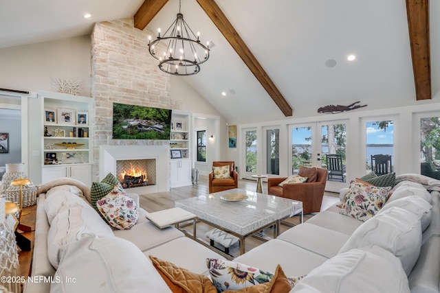 10351 County Road 13 N, Saint Augustine, FL 32092 - living room featuring high vaulted ceiling, beam ceiling, healthy amount of natural light, a large fireplace, and a chandelier