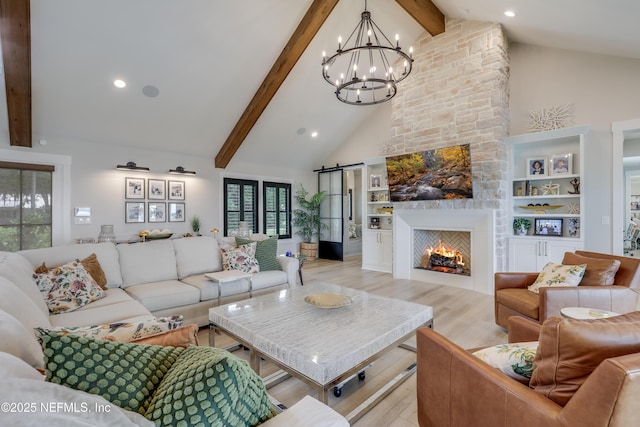 10351 County Road 13 N, Saint Augustine, FL 32092 - living room featuring high vaulted ceiling, beam ceiling, a chandelier, light wood-style flooring, and a stone fireplace