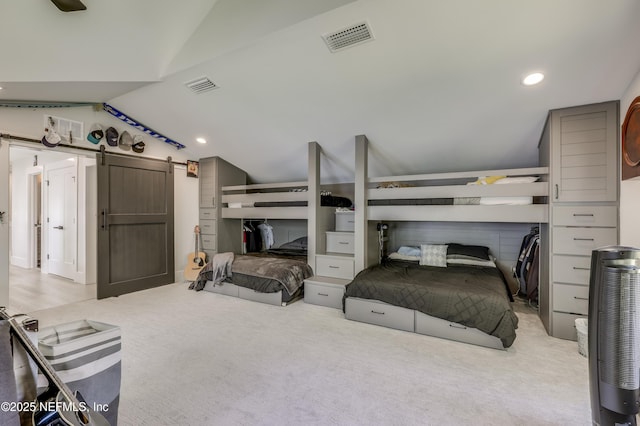 10351 County Road 13 N, Saint Augustine, FL 32092 - carpeted bedroom with lofted ceiling, a barn door, and recessed lighting