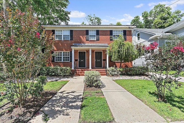 1838 Cherry St, Jacksonville, FL 32205 - view of property featuring brick siding, a front lawn, and a porch
