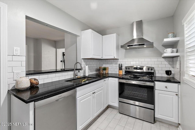 1838 Cherry St, Jacksonville, FL 32205 - kitchen with appliances with stainless steel finishes, wall chimney range hood, tasteful backsplash, and white cabinetry