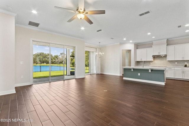 96167 Grande Oaks Ln, Fernandina Beach, FL 32034 - unfurnished living room with ornamental molding, a chandelier, dark wood-style floors, baseboards, and a ceiling fan