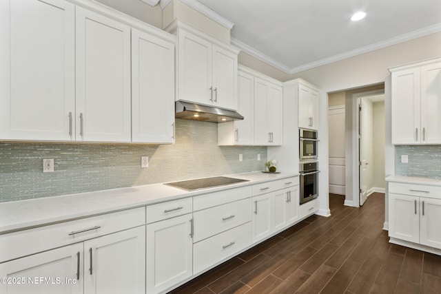 96167 Grande Oaks Ln, Fernandina Beach, FL 32034 - kitchen with black electric cooktop, under cabinet range hood, light countertops, crown molding, and white cabinets