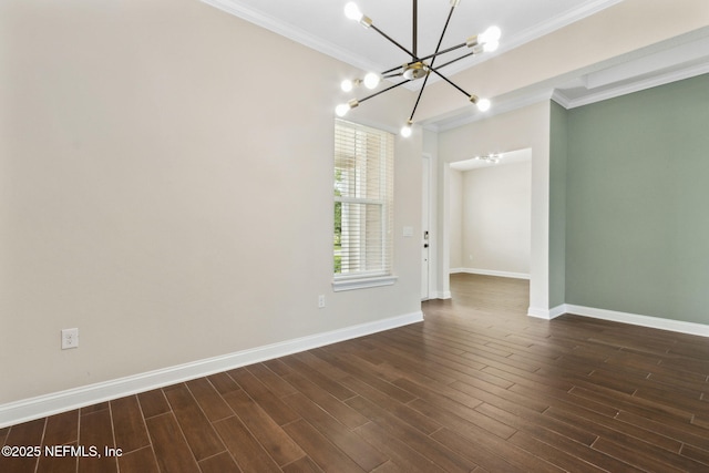 96167 Grande Oaks Ln, Fernandina Beach, FL 32034 - spare room featuring crown molding, a chandelier, baseboards, and dark wood-type flooring