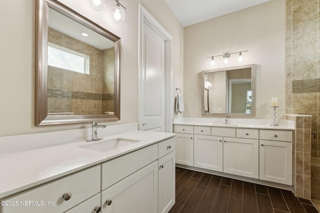 96167 Grande Oaks Ln, Fernandina Beach, FL 32034 - full bathroom with two vanities, tiled shower, and wood finished floors