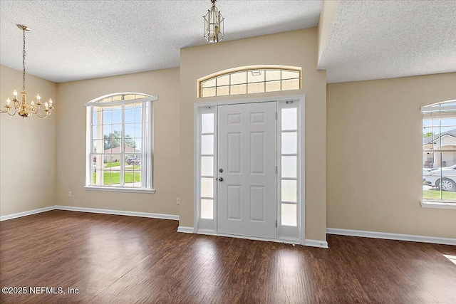 639 English Meadows Ct, Orange Park, FL 32073 - foyer with wood finished floors, a textured ceiling, a chandelier, plenty of natural light, and baseboards