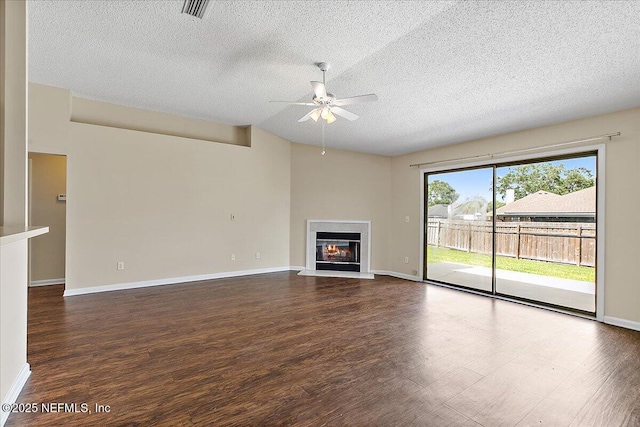 639 English Meadows Ct, Orange Park, FL 32073 - unfurnished living room with ceiling fan, a textured ceiling, wood finished floors, a glass covered fireplace, and baseboards