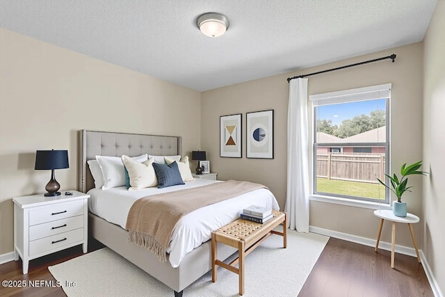 639 English Meadows Ct, Orange Park, FL 32073 - bedroom with dark wood-style floors, baseboards, and a textured ceiling