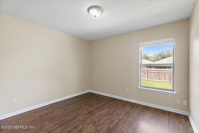 639 English Meadows Ct, Orange Park, FL 32073 - unfurnished room with dark wood-type flooring, baseboards, and a textured ceiling
