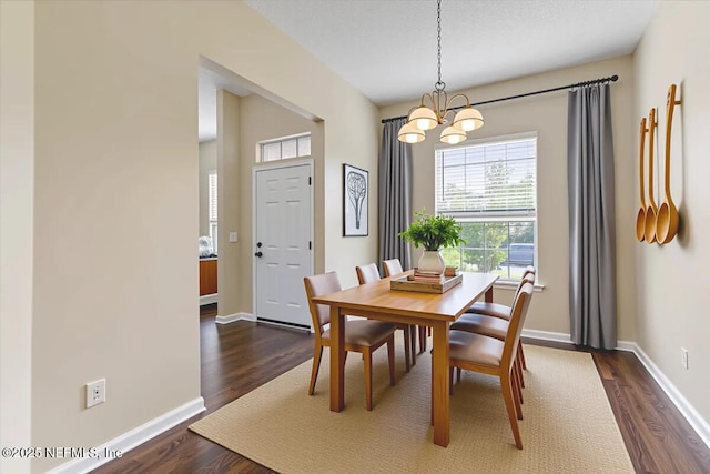 5631 Ortega Park Blvd, Jacksonville, FL 32244 - dining area featuring a chandelier, dark wood-style floors, and baseboards