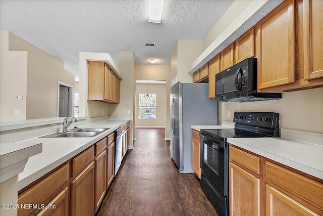 5631 Ortega Park Blvd, Jacksonville, FL 32244 - kitchen with black appliances, a sink, dark wood-style flooring, light countertops, and a textured ceiling
