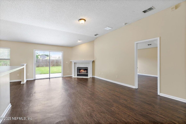 5631 Ortega Park Blvd, Jacksonville, FL 32244 - unfurnished living room with wood finished floors, a fireplace with flush hearth, a textured ceiling, and baseboards
