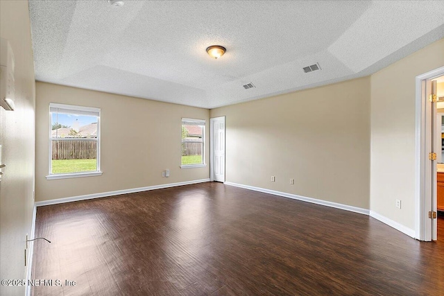 5631 Ortega Park Blvd, Jacksonville, FL 32244 - empty room featuring dark wood-type flooring, a textured ceiling, and baseboards