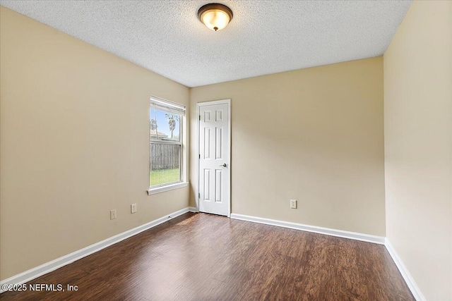 5631 Ortega Park Blvd, Jacksonville, FL 32244 - empty room with dark wood-style floors, baseboards, and a textured ceiling