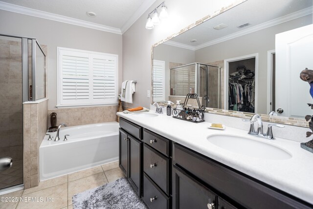 2538 Las Calinas Blvd, Saint Augustine, FL 32095 - full bathroom featuring a shower stall, double vanity, tile patterned floors, a bath, and a walk in closet