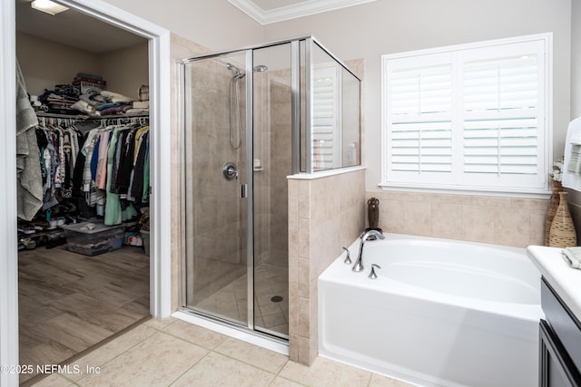 2538 Las Calinas Blvd, Saint Augustine, FL 32095 - bathroom featuring a bath, ornamental molding, a shower stall, a spacious closet, and tile patterned floors