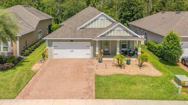 2538 Las Calinas Blvd, Saint Augustine, FL 32095 - craftsman house featuring a porch, a garage, a shingled roof, decorative driveway, and a front yard