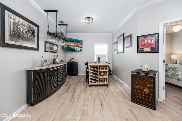2538 Las Calinas Blvd, Saint Augustine, FL 32095 - dining area with a dry bar, light wood finished floors, crown molding, and baseboards