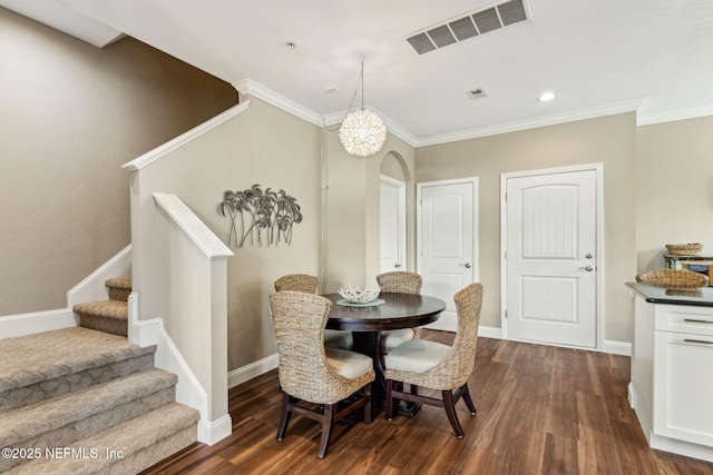 1899 White Sands Way Unit 704, Fernandina Beach, FL 32034 - dining room featuring dark wood-type flooring, arched walkways, stairs, ornamental molding, and baseboards