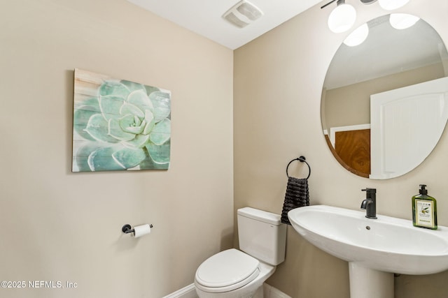 1899 White Sands Way Unit 704, Fernandina Beach, FL 32034 - bathroom featuring toilet, baseboards, and a sink