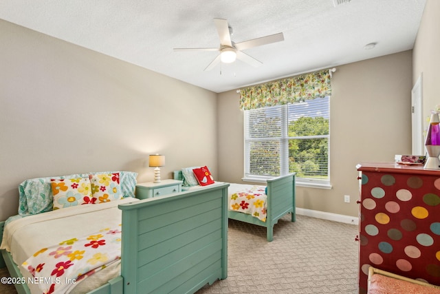 1899 White Sands Way Unit 704, Fernandina Beach, FL 32034 - bedroom featuring light colored carpet, baseboards, ceiling fan, and a textured ceiling
