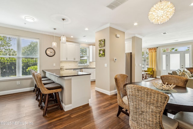 1899 White Sands Way Unit 704, Fernandina Beach, FL 32034 - dining space featuring crown molding, dark wood-style floors, baseboards, and recessed lighting