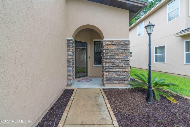 203 Buck Run Way, Saint Augustine, FL 32092 - doorway to property with stucco siding and stone siding