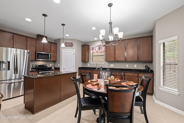 203 Buck Run Way, Saint Augustine, FL 32092 - kitchen with appliances with stainless steel finishes, a kitchen island, a chandelier, hanging light fixtures, and recessed lighting