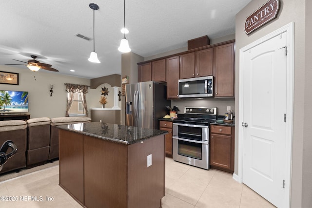 203 Buck Run Way, Saint Augustine, FL 32092 - kitchen with stainless steel appliances, open floor plan, a center island, ceiling fan, and dark stone countertops