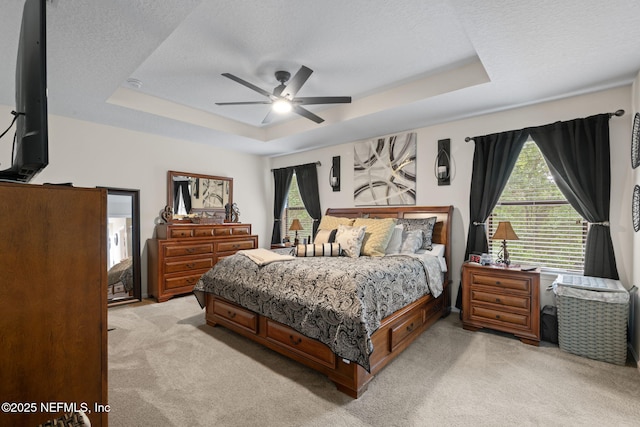 203 Buck Run Way, Saint Augustine, FL 32092 - bedroom with light colored carpet, a tray ceiling, a textured ceiling, and ceiling fan