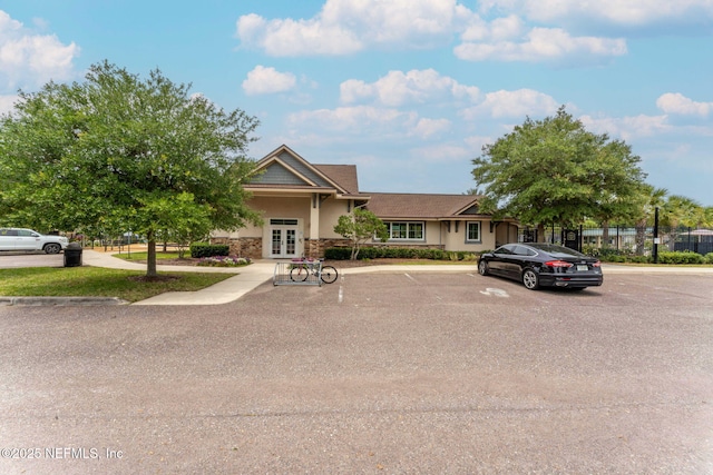 203 Buck Run Way, Saint Augustine, FL 32092 - view of front of house featuring french doors, stucco siding, uncovered parking, and stone siding