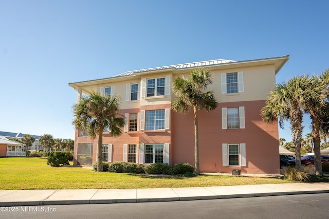 225 Atlantis Cir Unit 101-A, Saint Augustine Beach, FL 32080 - view of front of home with a front lawn and stucco siding