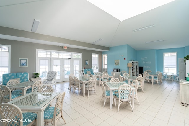 225 Atlantis Cir Unit 101-A, Saint Augustine Beach, FL 32080 - dining room with healthy amount of natural light, light tile patterned floors, french doors, and lofted ceiling